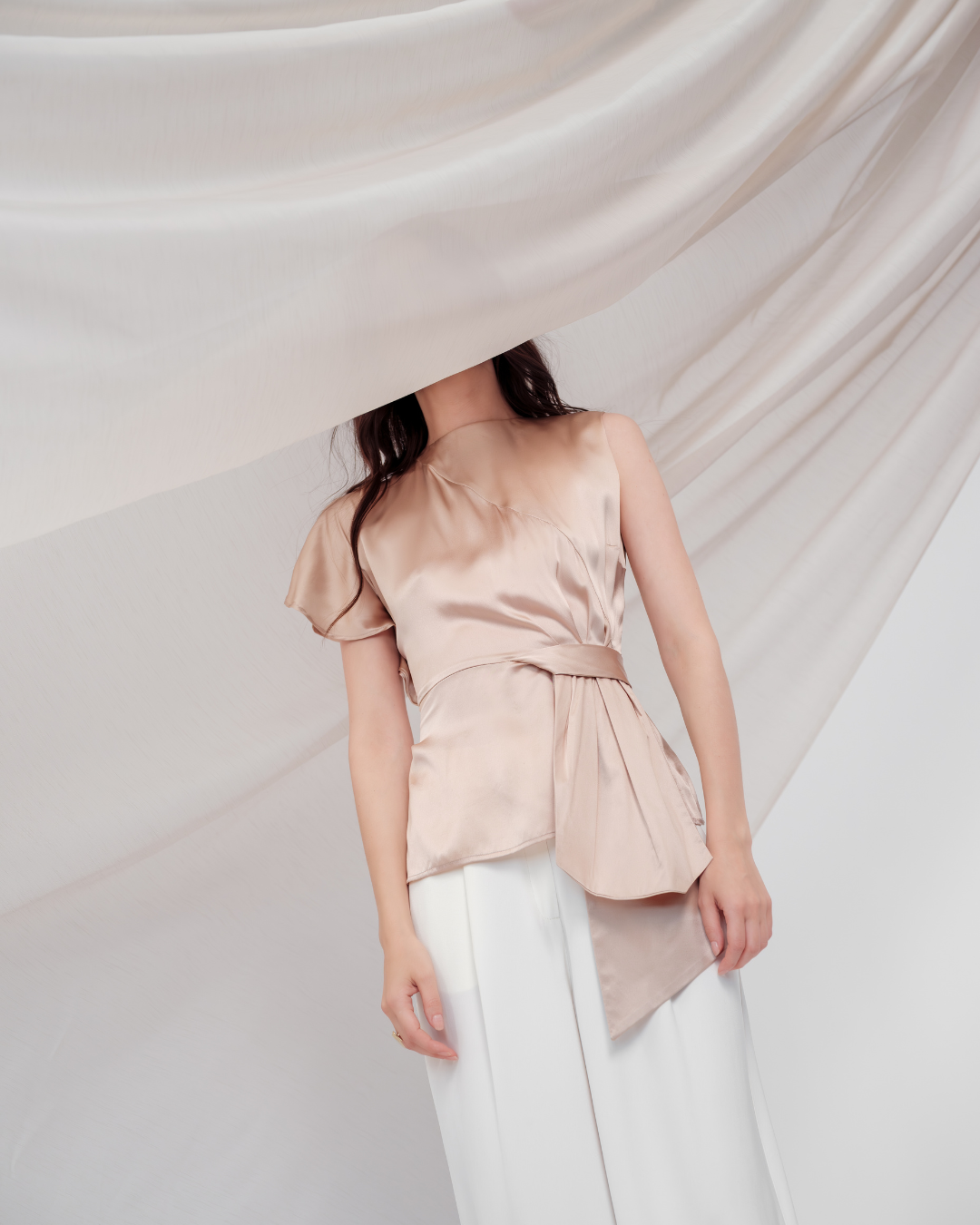 Golden Poise Top in 100% certified Como silk features an asymmetric bow and tailored silhouette, perfect for achieving both professional and evening elegance.