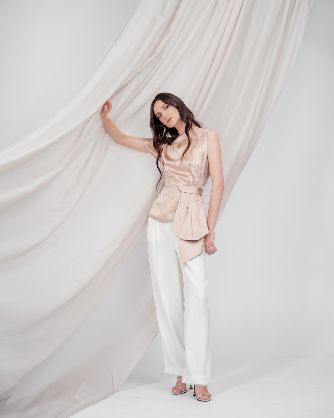 Golden Poise Top in 100% certified Como silk features an asymmetric bow and tailored silhouette, perfect for achieving both professional and evening elegance.