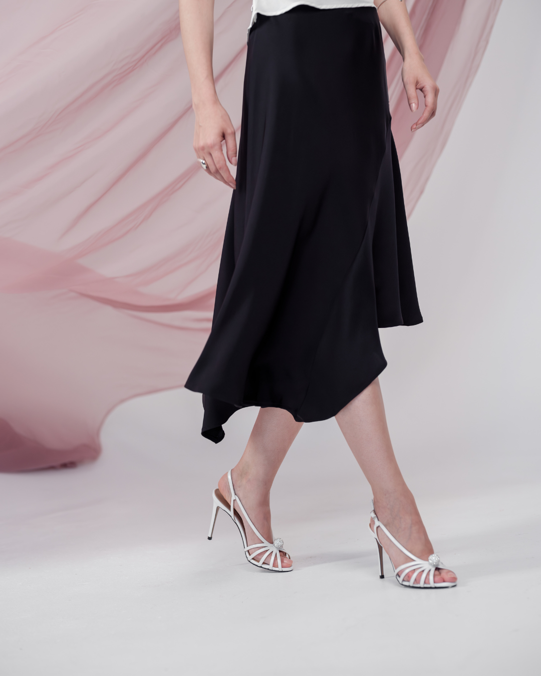 Celeste Cascade Skirt in 100% certified Como silk features an elasticated waistband and cascading hemline, offering refined elegance for day-to-night style.