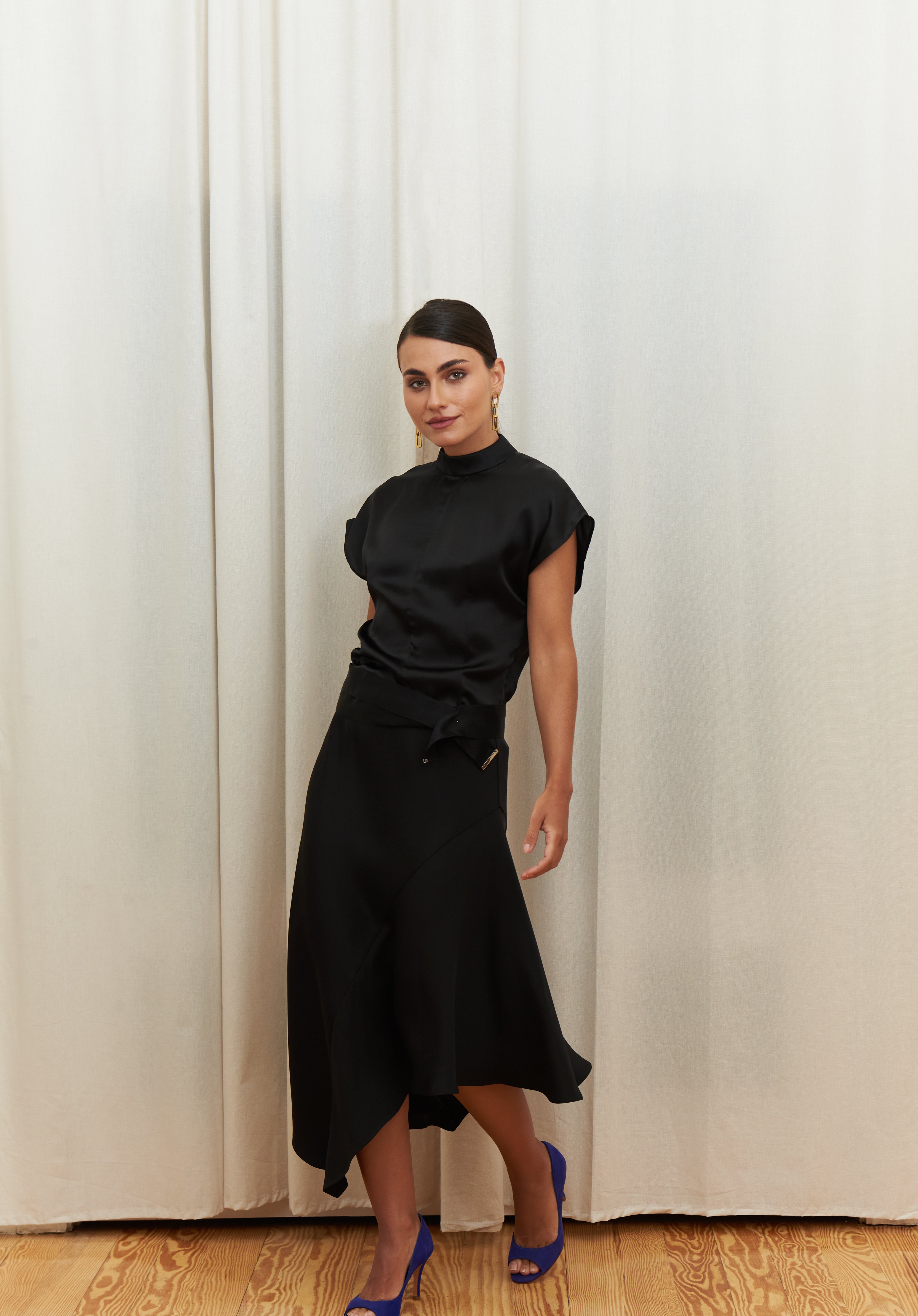 Midnight Muse Top, crafted from 100% certified Como silk, features a sleek silhouette with a refined V-neckline at the back. Its elegant drape and timeless design offer a sophisticated touch, effortlessly transitioning from daytime refinement to evening allure.