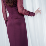 Amethyst Grace Dress in rich burgundy features a golden zamak accessory, sheer sleeves, and silk-covered buttons for opulent sophistication at formal events.