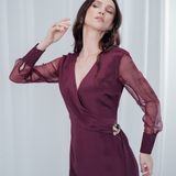 Amethyst Grace Dress in rich burgundy features a golden zamak accessory, sheer sleeves, and silk-covered buttons for opulent sophistication at formal events.