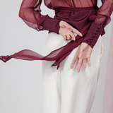 Berry Dusk Blouse in rich burgundy hue features a wrap design with silk-covered buttons and an adjustable waist tie - perfect for sophisticated day-to-evening wear.