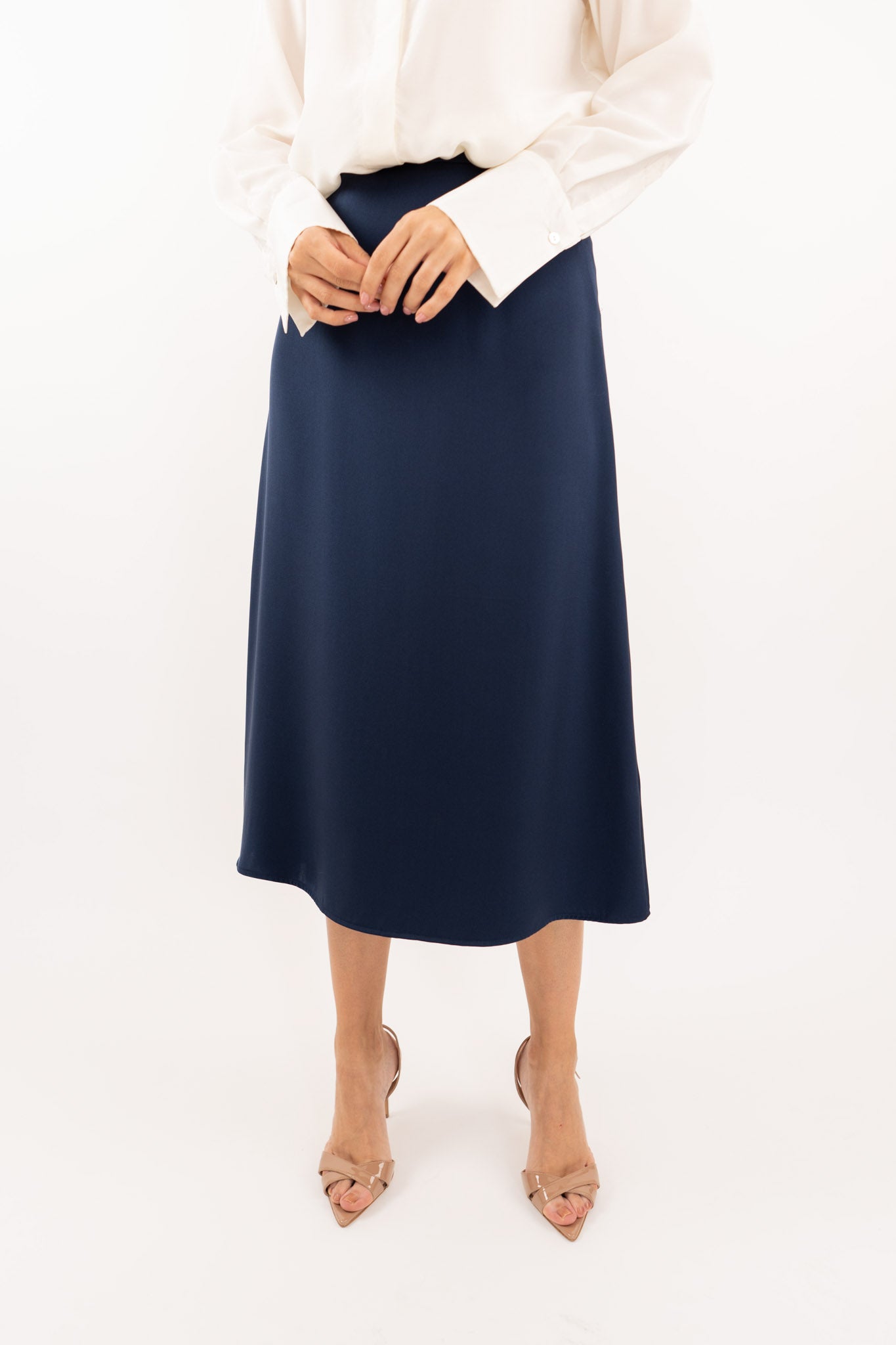 Close-up of navy-blue midi silk skirt, showcasing the smooth silk texture and refined stitching details.