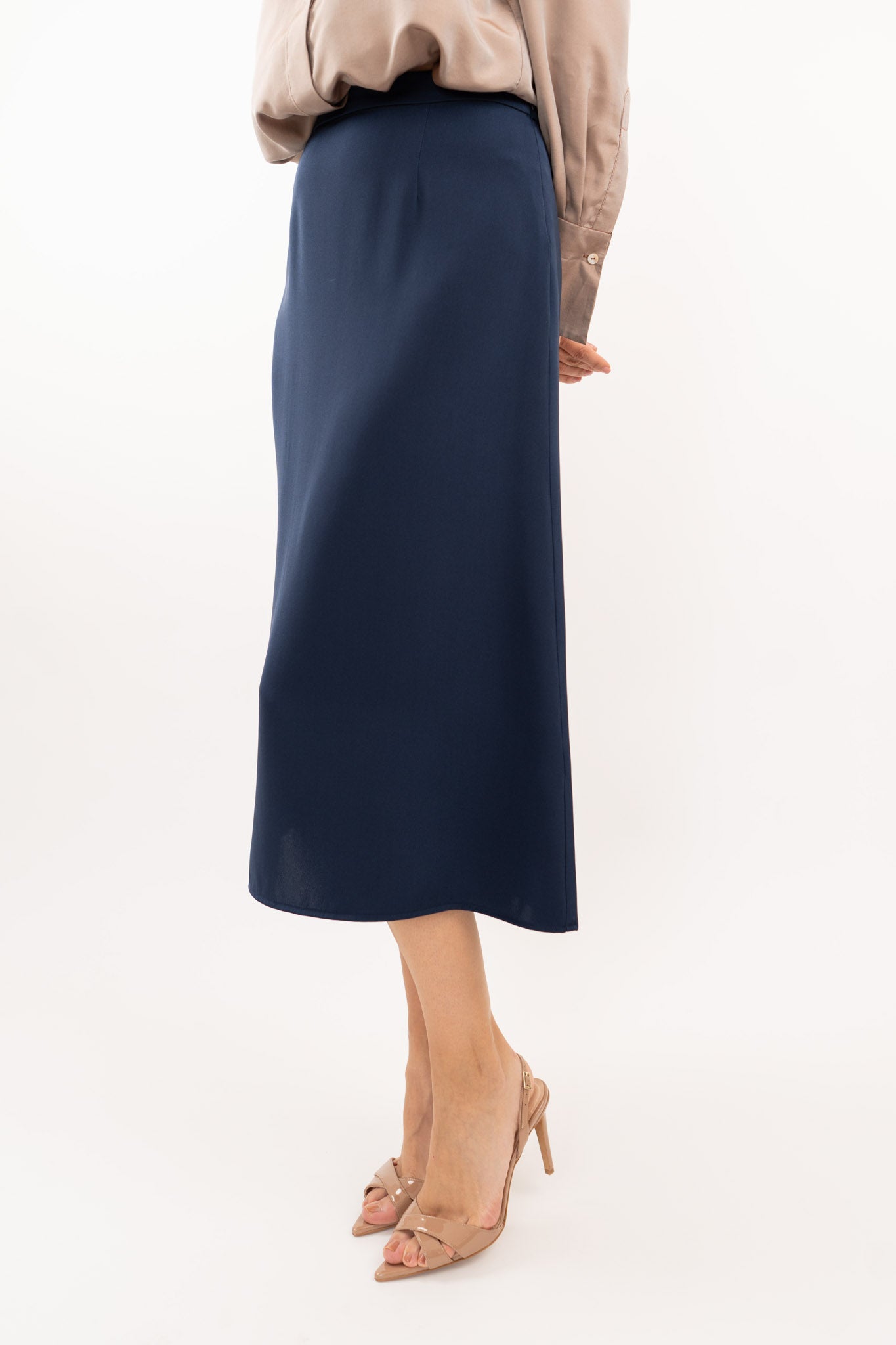 Close-up of navy-blue midi silk skirt, showcasing the smooth silk texture and refined stitching details.