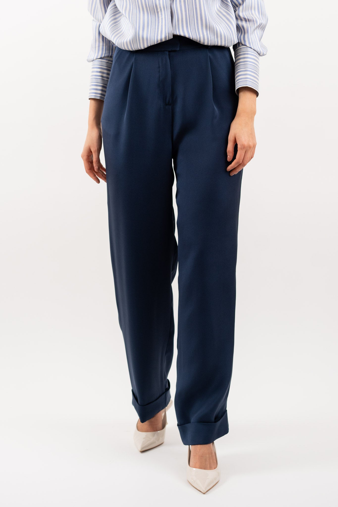 Close-up of navy blue tailored silk trousers, showcasing the soft sheen of silk blend fabric, impeccable stitching, and refined craftsmanship.