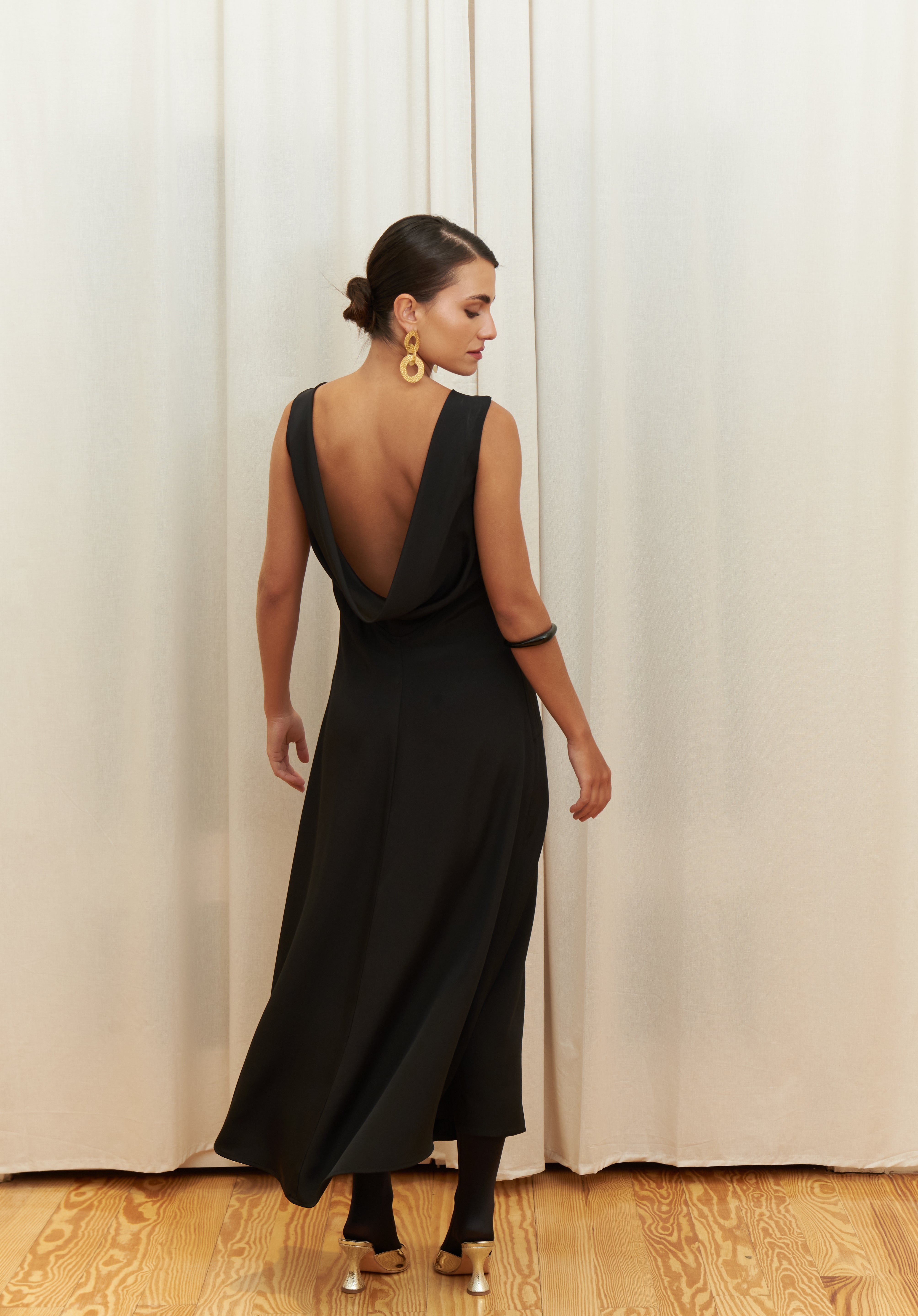 Audrey Serenity Gown in 100% certified Como silk features a round neckline and draped open back, offering timeless sophistication for formal occasions.