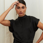Midnight Muse Top, crafted from 100% certified Como silk, features a sleek silhouette with a refined V-neckline at the back. Its elegant drape and timeless design offer a sophisticated touch, effortlessly transitioning from daytime refinement to evening allure.