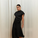 Midnight Muse Top, crafted from 100% certified Como silk, features a sleek silhouette with a refined V-neckline at the back. Its elegant drape and timeless design offer a sophisticated touch, effortlessly transitioning from daytime refinement to evening allure.
