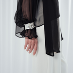 Noir Veil Blouse in 100% certified Como silk voile offers sheer elegance with voluminous sleeves and a delicate necktie—ideal for refined, modern styling.