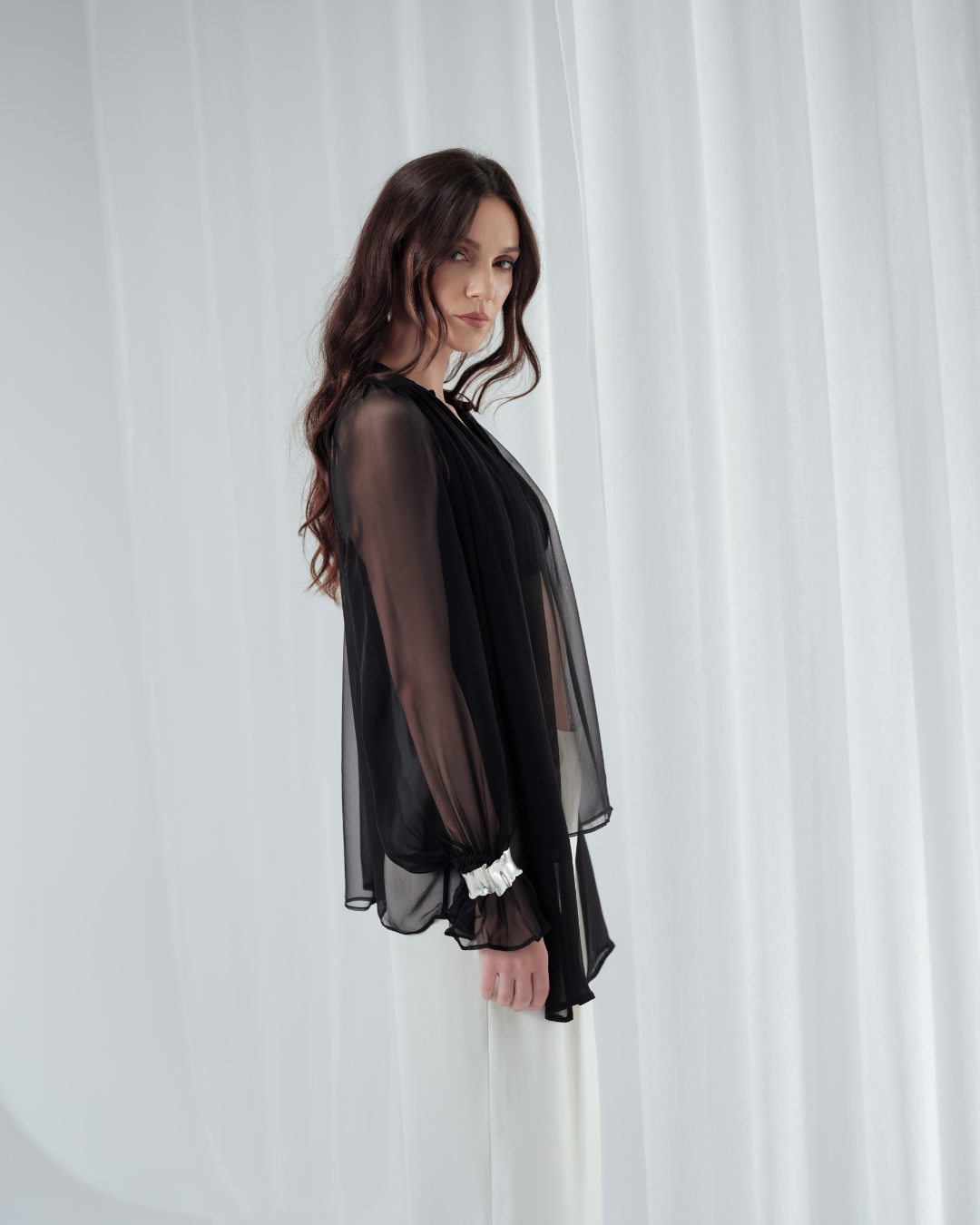 Noir Veil Blouse in 100% certified Como silk voile offers sheer elegance with voluminous sleeves and a delicate necktie—ideal for refined, modern styling.