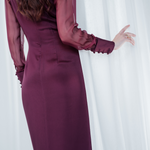 Amethyst Grace Dress in rich burgundy features a golden zamak accessory, sheer sleeves, and silk-covered buttons for opulent sophistication at formal events.