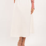 Ivory midi silk skirt – close-up of luxurious 100% silk fabric, precise stitching, and exquisite craftsmanship.