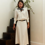 Ivory midi silk skirt – close-up of luxurious 100% silk fabric, precise stitching, and exquisite craftsmanship.
