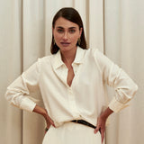 Ivory silk shirt – classic button-up design in 100% silk with an elegant drape and subtle sheen. Front view.