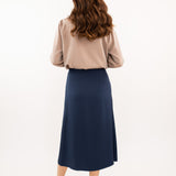 Navy-blue midi silk skirt in 100% silk, smooth and seamless finish, high-waisted fit, back view.
