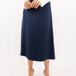 Close-up of navy-blue midi silk skirt, showcasing the smooth silk texture and refined stitching details.