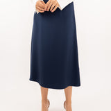 Close-up of navy-blue midi silk skirt, showcasing the smooth silk texture and refined stitching details.