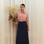 Navy-blue midi silk skirt in 100% silk, smooth and seamless finish, high-waisted fit, back view.