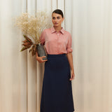 Navy-blue midi silk skirt in 100% silk, smooth and seamless finish, high-waisted fit, back view.