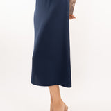 Close-up of navy-blue midi silk skirt, showcasing the smooth silk texture and refined stitching details.