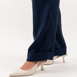 Close-up of navy blue tailored silk trousers, showcasing the soft sheen of silk blend fabric, impeccable stitching, and refined craftsmanship.