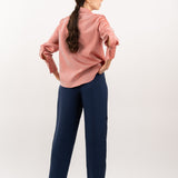 Peach pink silk shirt – smooth silk fabric with a seamless back and tailored finish for timeless elegance. Back view.