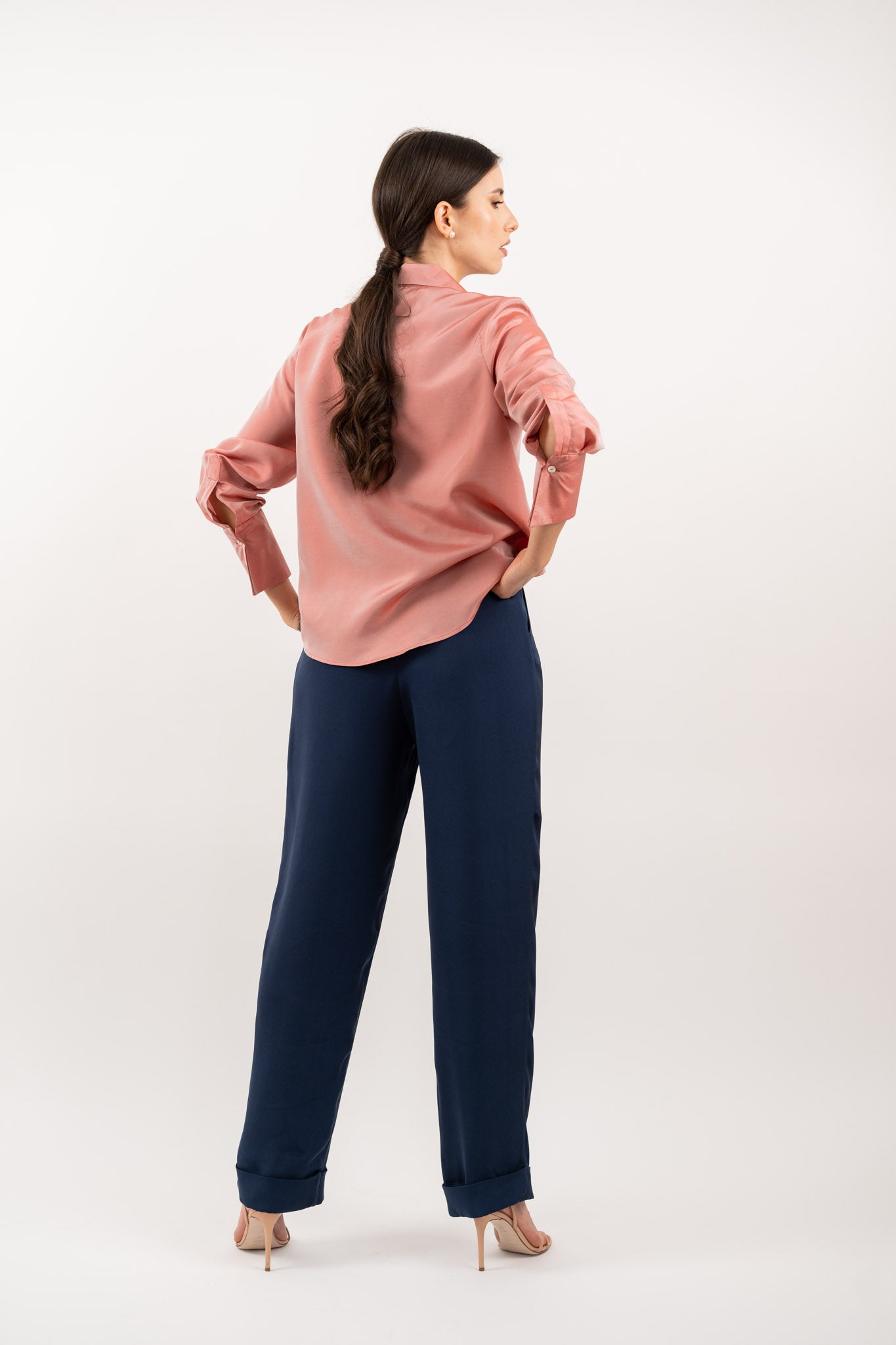 Peach pink silk shirt – smooth silk fabric with a seamless back and tailored finish for timeless elegance. Back view.
