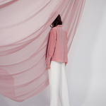 Peach pink silk shirt – soft pastel silk blouse with a relaxed fit and delicate sheen, crafted from 100% silk. Front view.