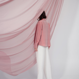 Peach pink silk shirt – soft pastel silk blouse with a relaxed fit and delicate sheen, crafted from 100% silk. Front view.
