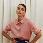 Peach pink silk shirt – soft pastel silk blouse with a relaxed fit and delicate sheen, crafted from 100% silk. Front view.