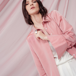 Peach pink silk shirt – soft pastel silk blouse with a relaxed fit and delicate sheen, crafted from 100% silk. Front view.