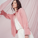 Peach pink silk shirt – soft pastel silk blouse with a relaxed fit and delicate sheen, crafted from 100% silk. Front view.